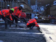 The concrete needs a smooth finish before the asphalt road surface is put down. Image: NZTA.
