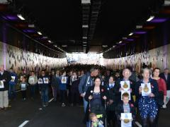 Descendants of the WW1 New Zealand Tunnelling Company lead the crowd through Arras Tunnel. Image: NZTA.
