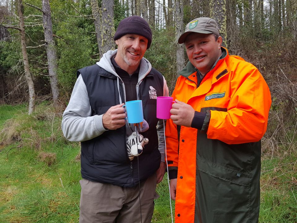 Andrew with Matt Howell. You will have to watch the video to find out why they are holding these cups. Image: LEARNZ.