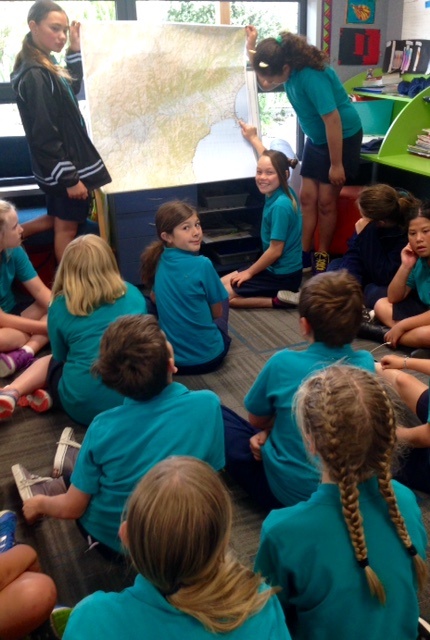 Students from Kaikōura Primary School with one of the maps they won.