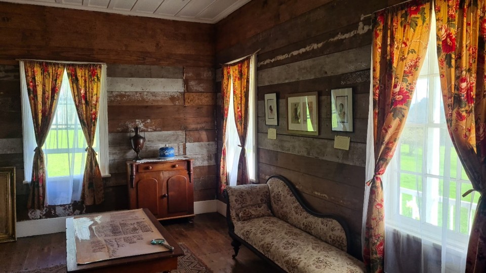 Inside the mission house, you can still see the original table on which the Treaty was signed with a copy of the Treaty on it. Image: LEARNZ.